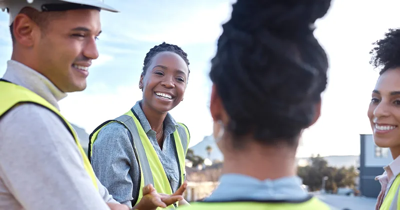 Importance of communication in construction symbolized by chatting building staff